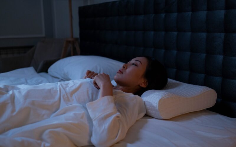 Woman in White Pajama Lying on the Bed